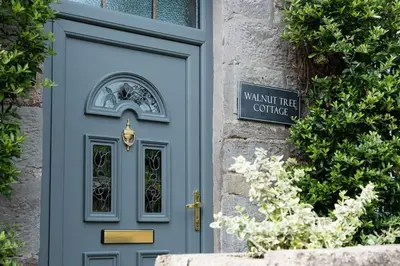 a blue door on a building with a sign on it at Luxury Cottage near Hay-on-Wye in Llanigon