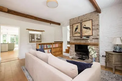 a living room with a couch and a fireplace at Luxury Cottage near Hay-on-Wye in Llanigon