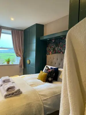 a bedroom with a large bed with towels on it at Kennet House in Ludlow