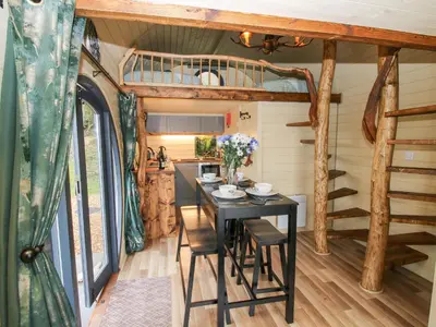 a dining room with a table in a tiny house at Callow Pod in Shrewsbury