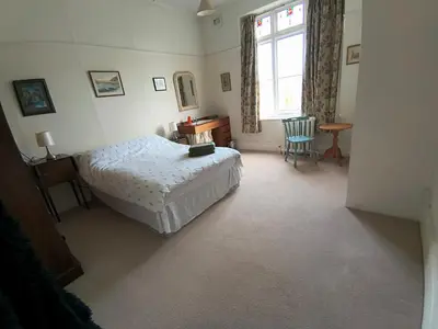 a bedroom with a bed and a desk and a window at Tranquil getaway near Brecon Beacons in Llandovery