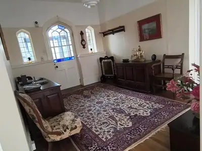 a room with a desk and a chair and a rug at Tranquil getaway near Brecon Beacons in Llandovery