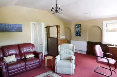 a living room with a couch and a chair at Country Mansion - Private Annexe in Llanwrda