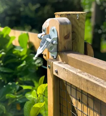 a wooden fence with a gun on it at 'Villager' the Yurt at Pentref Luxury Camping in Penuwch