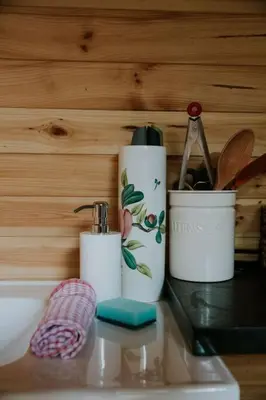 two white cups sitting on top of a sink at River Side Cabin with Hot tub Snowdonia in Barmouth
