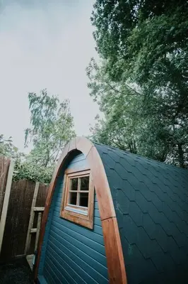 a small blue house with a window on top of it at River Side Cabin with Hot tub Snowdonia in Barmouth