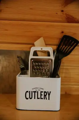 a container of cutlery sitting on a table at Willow Cabin & Hot Tub in Barmouth