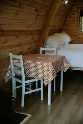 a room with a table and two chairs and a bed at Oak SPECIAL WINTER OFFERS - Hot tub in Barmouth