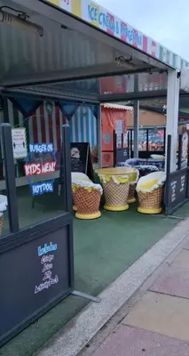 a food stand with wicker baskets on the sidewalk at Chalet 88 in Aberystwyth