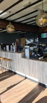 a bar in a restaurant with a counter at Chalet 88 in Aberystwyth