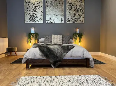 a bedroom with a bed with a furry blanket at Quirky, Luxury Hideaway in Llanbrynmair
