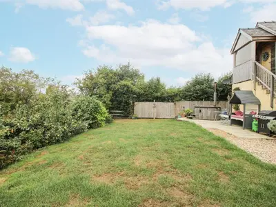 a yard with a fence and a house at Stable Cottage in Bishops Castle