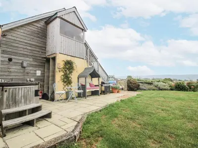 a view of the side of a house with a patio at Stable Cottage in Bishops Castle