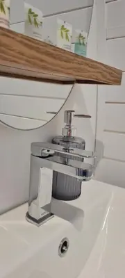 a silver faucet on top of a white sink at Eastridge Glamping Pods in Shrewsbury