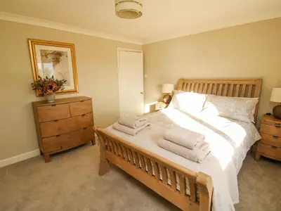 a bedroom with a large bed with towels on it at The Marshes in Welshpool