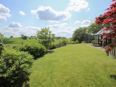 a view of a yard with a house at The Marshes in Welshpool