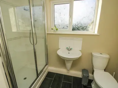 a bathroom with a shower and a toilet and a sink at The Marshes in Welshpool