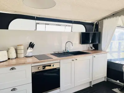 a kitchen with a sink and a stove in an rv at Heron in Nantmel