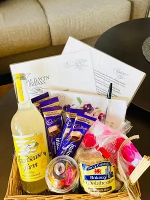 a basket filled with food and a bottle of milk at King Fisher in Nantmel
