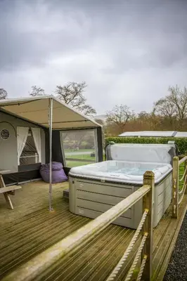 a hot tub on a deck with a tent at King Fisher in Nantmel
