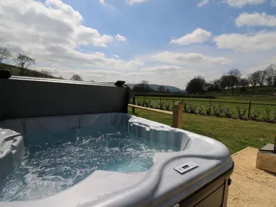 a jacuzzi tub with water in a backyard at King Fisher in Nantmel