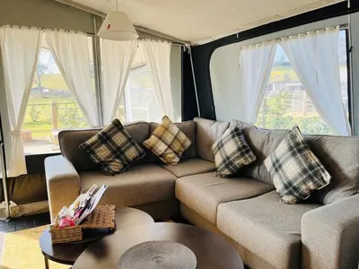a living room with a couch and a table at King Fisher in Nantmel