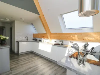 a kitchen with white cabinets and a window at Elan Valley Welsh - The Sheepfold in Llandrindod Wells