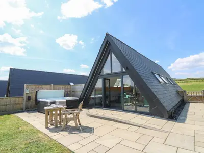 a house with a black roof and a patio at Kerry Hill - The Sheepfold in Llandrindod Wells