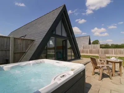 a hot tub in the backyard of a house at Kerry Hill - The Sheepfold in Llandrindod Wells
