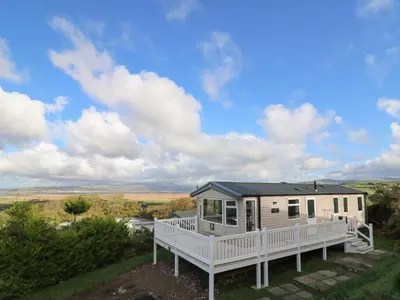 a mobile home with a porch and a deck at Gwent 74 in Borth