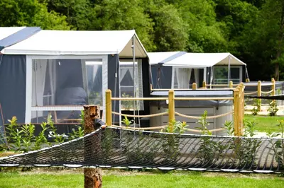 a group of tents in a yard with a net at Salmon in Nantmel