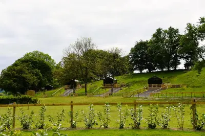 a field with some huts on top of a hill at Salmon in Nantmel