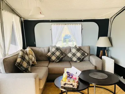 a living room with a couch and a table at Otter in Nantmel