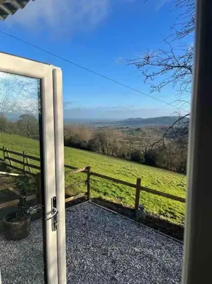 an open door with a view of a field at Ramblers retreat in Shrewsbury