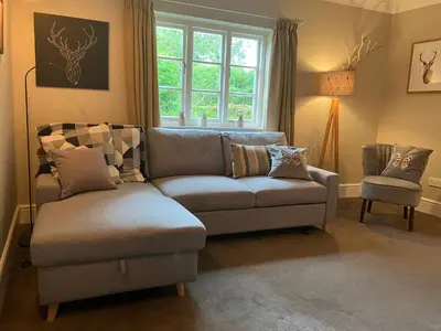 a living room with a couch and a chair at Divine, detached countryside cottage near Ludlow. in Ludlow