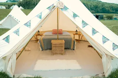 a tent with a bed inside of it at Fred's Yurts at Hay Festival in Hay-on-Wye