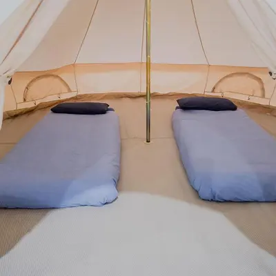 two blue pillows in a tent at Fred's Yurts at Hay Festival in Hay-on-Wye