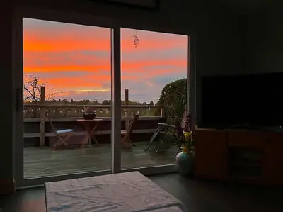 a view of a sunset from a room with a window at Countryside in the Town. in Harlescott