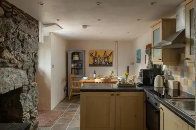 a kitchen with a sink and a counter top at Ysgoldy in Llanfor