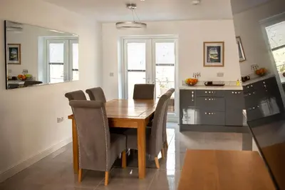 a dining room with a wooden table and chairs at RiverTree House in Llangollen