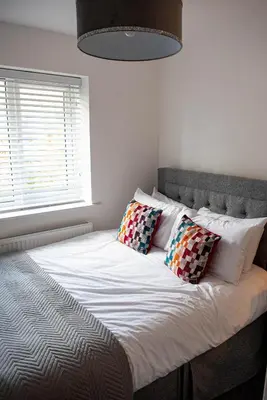 a bed with two pillows on it in a bedroom at RiverTree House in Llangollen