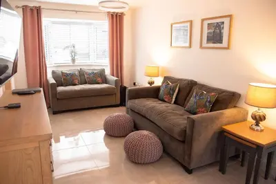 a living room with a couch and a chair at RiverTree House in Llangollen