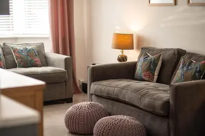 a living room with two chairs and a couch at RiverTree House in Llangollen