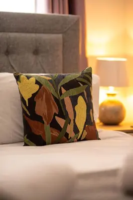 a pillow sitting on top of a bed at RiverTree House in Llangollen