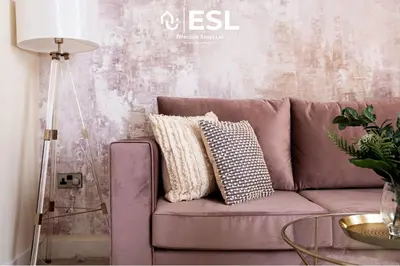 a purple couch with pillows in a living room at Super Central - Quiet - 2 Bedroom Cottage in Shrewsbury
