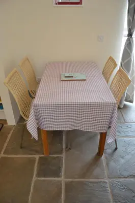 a table with chairs and a plate on top of it at Stone Cottage in Shrewsbury