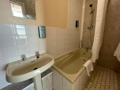 a bathroom with a sink and a bath tub at The Sandbanks in Barmouth