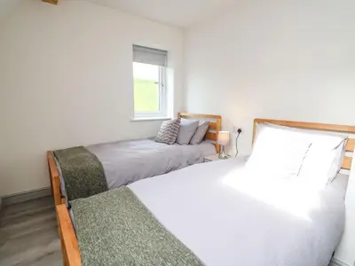 a bedroom with two beds and a window at Hill Radnor - The Sheepfold in Llandrindod Wells