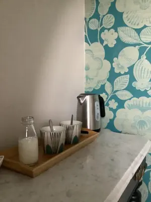 a kitchen counter with a shelf with cups and a blender at The Views Bed and Breakfast in Llangollen