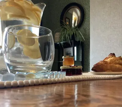 a glass of water and some bread on a table at The Views Bed and Breakfast in Llangollen